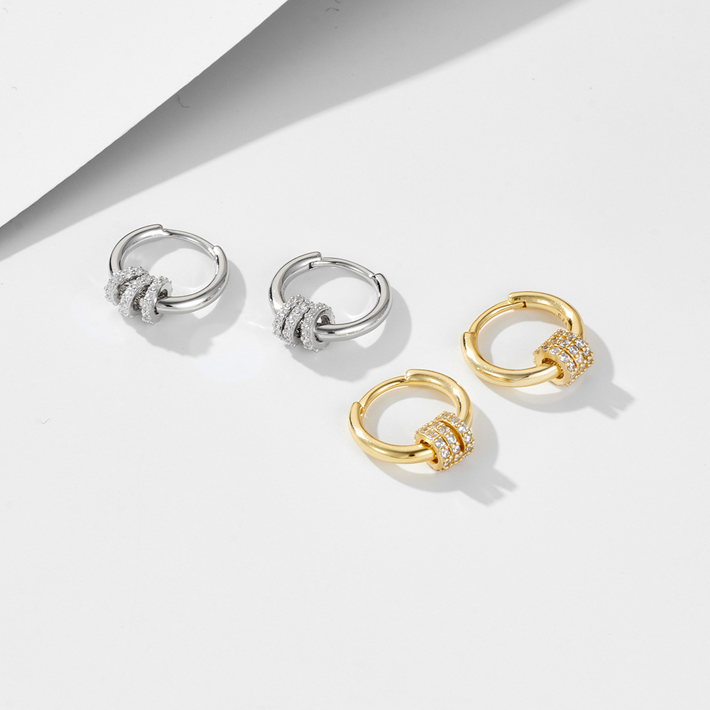 A pair of exquisite diamond-encrusted small hoop sterling silver drop earrings with a minimalist, trendy, and fashionable style.