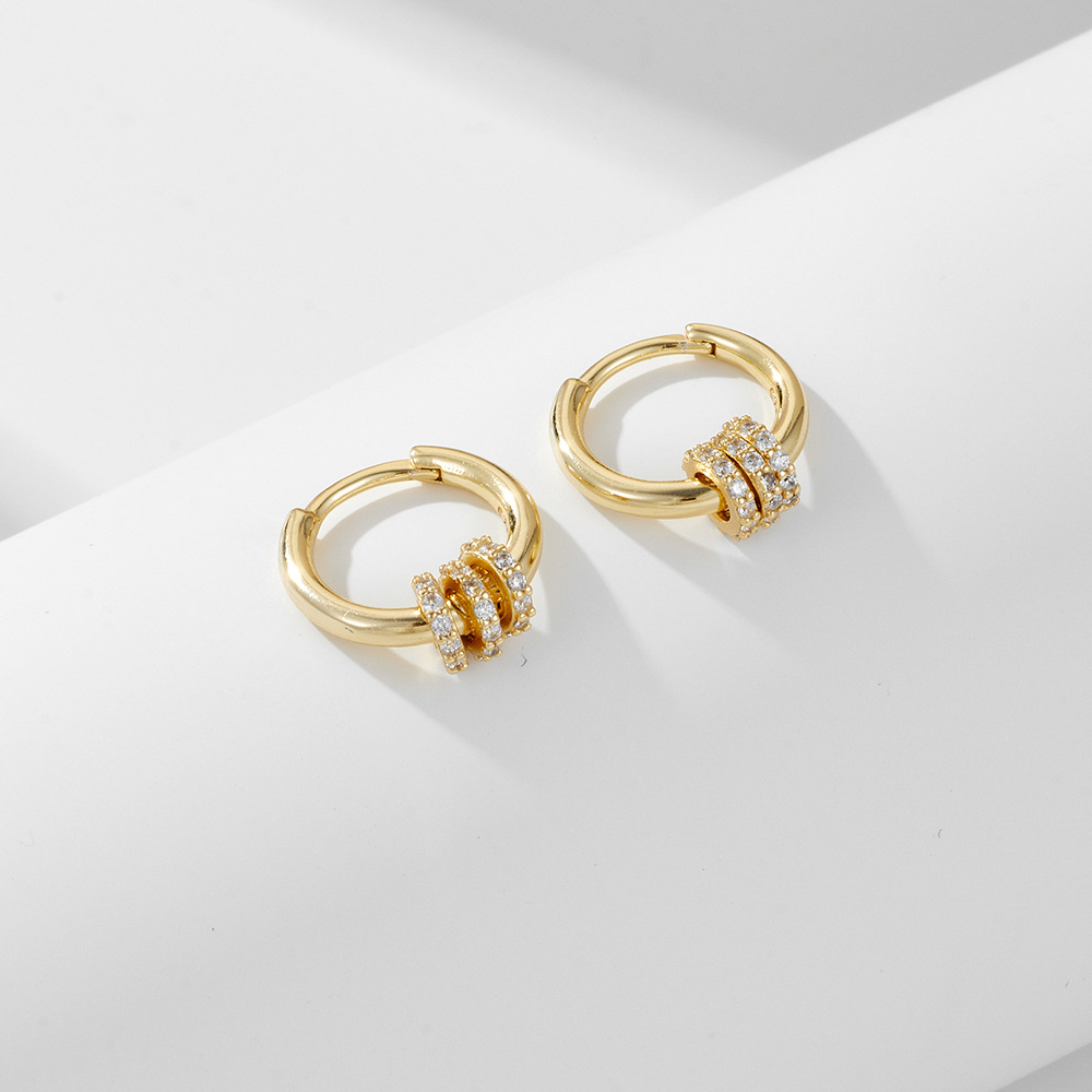 A pair of exquisite diamond-encrusted small hoop sterling silver drop earrings with a minimalist, trendy, and fashionable style.