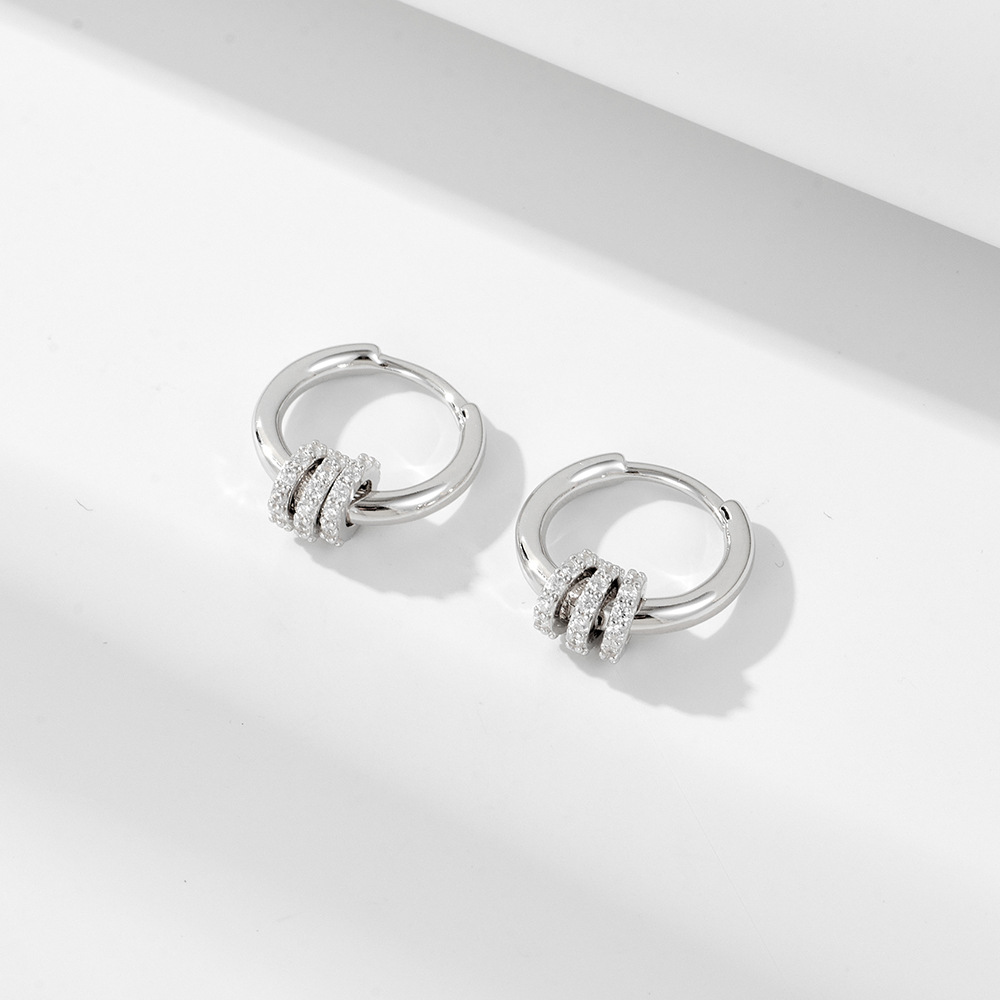 A pair of exquisite diamond-encrusted small hoop sterling silver drop earrings with a minimalist, trendy, and fashionable style.